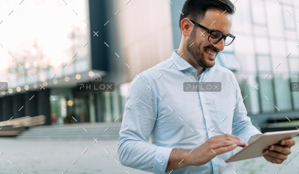 demo-attachment-1482-portrait-of-businessman-in-glasses-holding-tablet-AWVHCJU